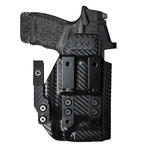 May include: Black handgun in a carbon fiber holster. The holster has two black clips and is secured with screws. The brand name "EYV" is visible on the holster.