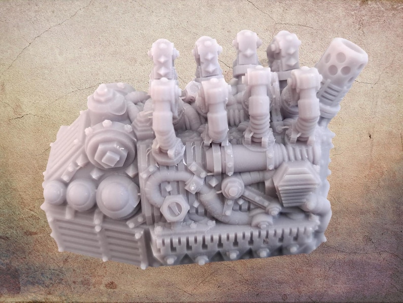 May include: A detailed, light gray miniature engine model with intricate mechanical components. The model features multiple cylinders, pipes, and gears, showcasing a complex design. The overall aesthetic suggests a steampunk or industrial theme.