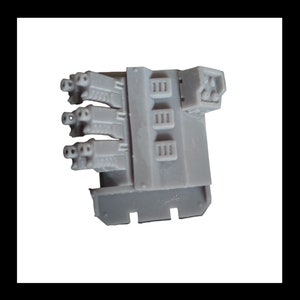 May include: A grey plastic model kit part with multiple small holes and a rectangular panel with three rows of rectangular openings.