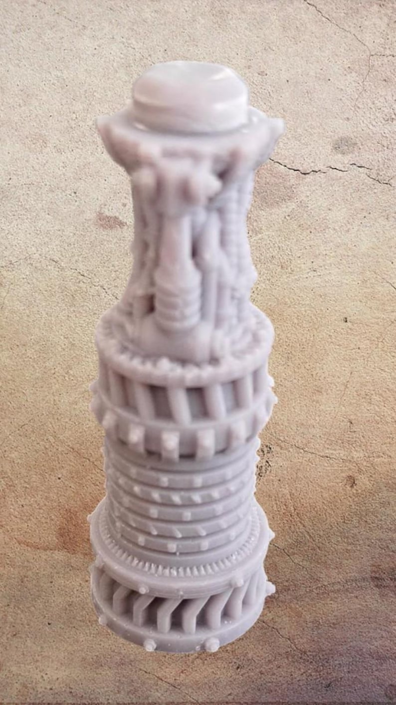 May include: A light purple, intricately detailed, 3D-printed sculpture resembling a stylized tower. The design features multiple levels with architectural elements and a rounded top. The sculpture is approximately 5 inches tall.