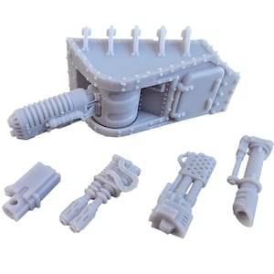 May include: A gray plastic model of a tank with a large cannon and several smaller guns. The tank is disassembled into several pieces, including the main body, the cannon, and the smaller guns.