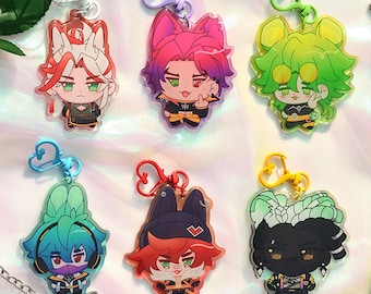 May include: Six colorful anime-style character keychains with different designs. Each keychain features a different character with unique hair colors, clothing, and accessories. The keychains are made of clear acrylic and have a heart-shaped metal ring.