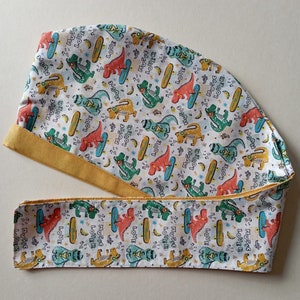 Reversible organic cotton dinosaur cap