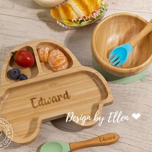 May include: A wooden car-shaped divided plate with the name "Edward" engraved on it. The plate has three sections, one for fruit, one for blueberries, and one for a larger portion. The plate is surrounded by a white background with the text "Design by Ellen" and a heart.