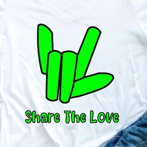 May include: White t-shirt with a green hand gesture and the text "Share The Love" printed on the front.