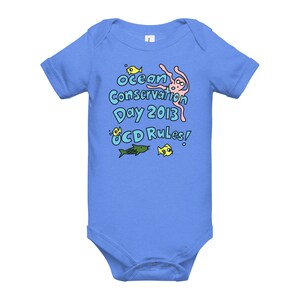May include: A light blue baby onesie with a graphic of an octopus, fish, and the text "Ocean Conservation Day 2013 OCD Rules!"