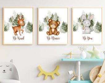 May include: Set of three framed art prints featuring watercolor illustrations of woodland animals: a deer, a bear, and a rabbit. Each print has a forest background and a motivational phrase: "Be Kind," "Be Brave," and "Be You."