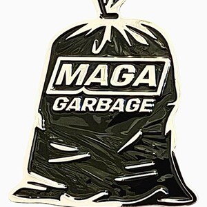 May include: Black and white enamel pin of a garbage bag with the text "Maga Garbage" on the front.