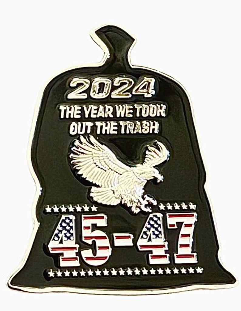 May include: A black and green metal pin shaped like a trash bag with a bald eagle and the text "2024 The Year We Took Out The Trash 45-47" in silver lettering.