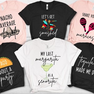 May include: Six different t-shirts with various designs and text related to a fiesta or party. The shirts are black, white, and pink. The text on the shirts includes "Nacho Average Bride", "Let's Get Smashed", "Shake Your Maracas", "Taco 'Bout A Party", "My Last Margarita As A Senorita", and "Tequila Made Me Do It".
