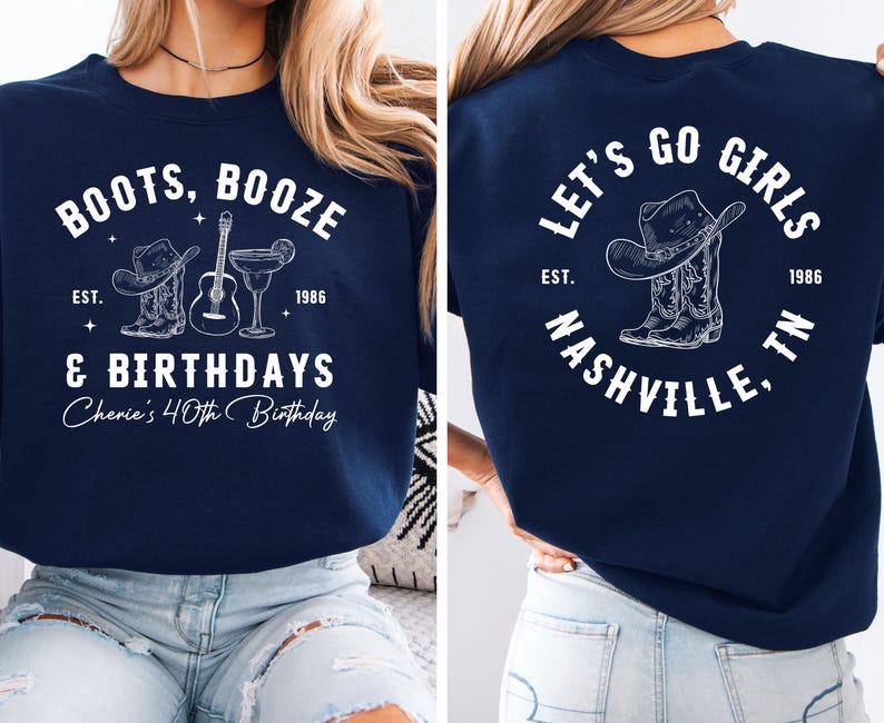 May include: Navy blue sweatshirt with white text and graphics. The front reads "BOOTS, BOOZE & BIRTHDAYS" with a cowboy hat, boots, guitar, and cocktail. The back says "LET'S GO GIRLS NASHVILLE, TN" with a cowboy hat and boots.