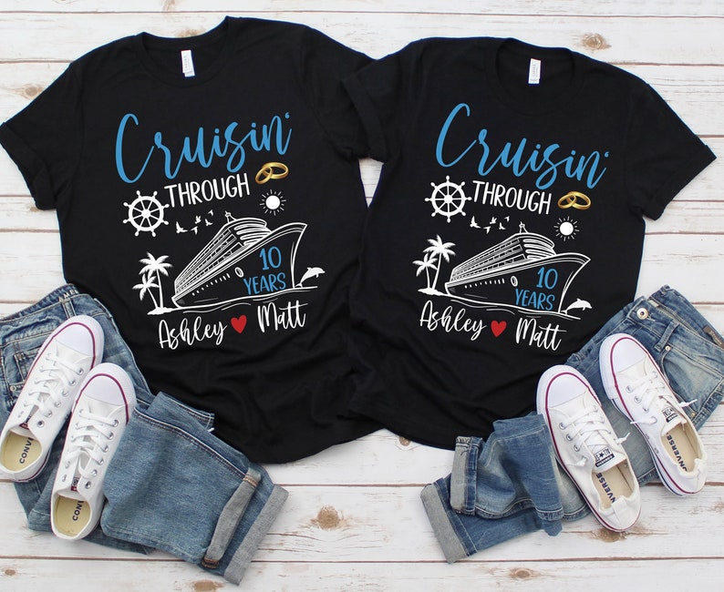 May include: Two black t-shirts with a white cruise ship and the text "Cruisin' Through 10 Years" with a gold ring graphic. The shirts have the names "Ashley" and "Matt" with a red heart in between.