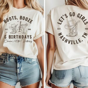 May include: Cream-colored t-shirt with front and back designs. The front features text "BOOTS, BOOZE & BIRTHDAYS" with a cowboy hat, guitar, and cocktail graphic. The back says "LET'S GO GIRLS NASHVILLE, TN" with a cowboy hat and boot graphic.