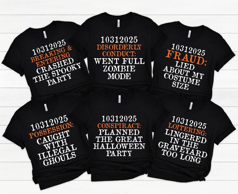May include: Six black t-shirts with Halloween-themed text in white and orange. The phrases include "Breaking & Entering," "Disorderly Conduct," "Fraud," "Possession," "Conspiracy," and "Loitering."