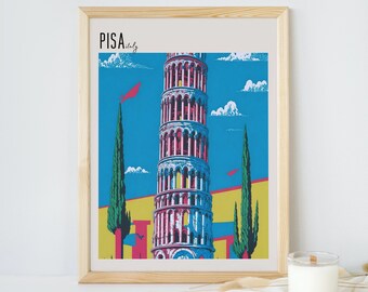 May include: A framed print of the Leaning Tower of Pisa in Italy. The tower is depicted in a colorful, stylized design with a blue sky and white clouds in the background. The text "PISA Italy" is in the top left corner of the print.