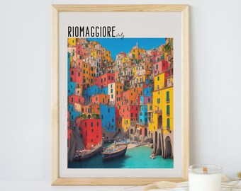 May include: A framed print of a colorful Italian village with the text "Riomaggiore, Italy" at the top. The village is built on a hillside and overlooks a turquoise bay with boats.