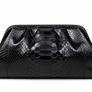 May include: A black clutch bag featuring a textured snakeskin pattern with a glossy finish. The bag has a structured frame with a hinged opening at the top, characterized by a wide, tapered shape and a smooth, dark surface texture throughout.