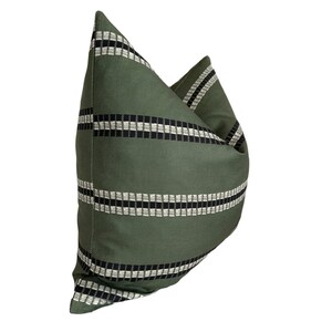 May include: Green pillow with black and white striped pattern.