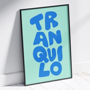 May include: A framed print with a light blue background and the word "TRANQUILO" written in large, blue, bubble letters.