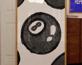 May include: A framed print of a black and white illustration of a pool ball with the number eight on it. The background is white with black circles.