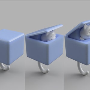 May include: A light blue cat-shaped hook with a cube-shaped box. The box has a lid that opens to reveal a white cat figurine. The hook is white and curved.