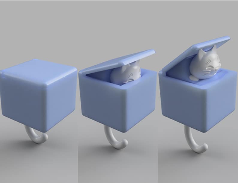 May include: A light blue cat-shaped hook with a cube-shaped box. The box has a lid that opens to reveal a white cat figurine. The hook is white and curved.