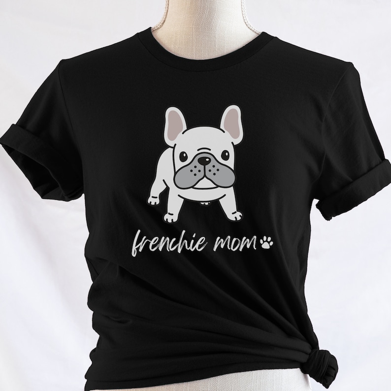 May include: Black t-shirt featuring a white French bulldog illustration and the text "frenchie mom" with a paw print.