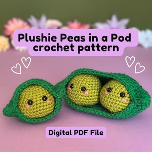 May include: A crocheted plushie pea pod with two smiling peas inside. The peas are yellow-green with black eyes and pink cheeks. The pod is green, and the text "Plushie Peas in a Pod crochet pattern" is displayed above. The words "Digital PDF File" are at the bottom.