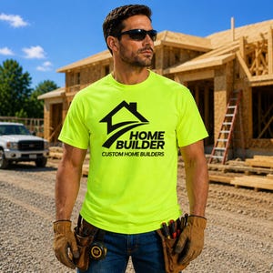 May include: A neon yellow short-sleeve t-shirt featuring a black graphic of a house silhouette above the text "HOME BUILDER" and "CUSTOM HOME BUILDERS". The shirt is worn with blue denim jeans and tan leather work gloves with a tool belt.
