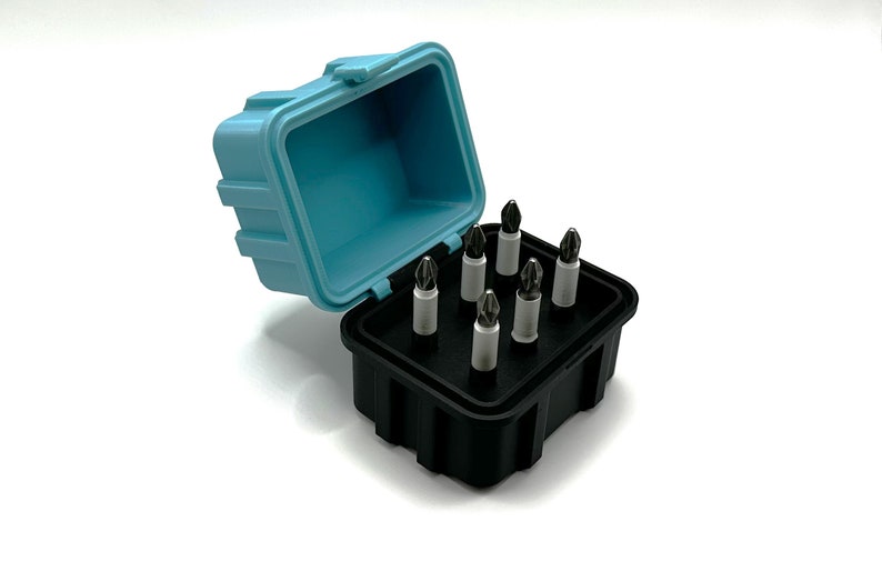 May include: A set of eight screwdriver bits in a black and blue plastic case. The case is open and the bits are arranged in a grid pattern.