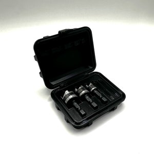 May include: A black plastic case with a set of four drill bits. The drill bits are labeled with the numbers 12, 16, 19, and 22.