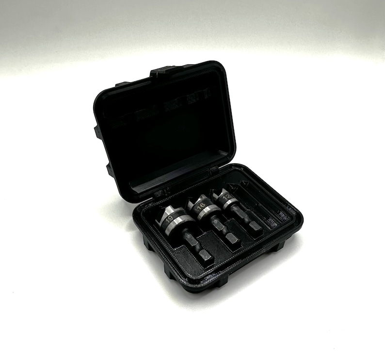 May include: A black plastic case with a set of four drill bits. The drill bits are labeled with the numbers 12, 16, 19, and 22.