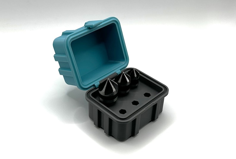 May include: A black plastic case with a blue lid, open to reveal three black, pointed tools. The tools are arranged in the case's three designated slots.