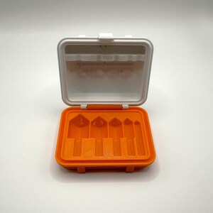 May include: An orange plastic case with six slots for holding small tools. The case is open and the slots are empty.