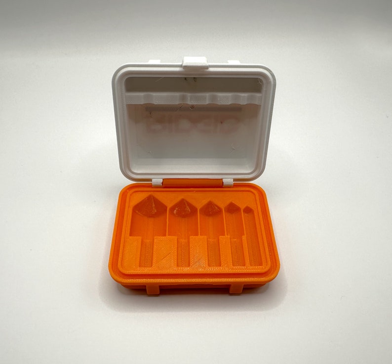 May include: An orange plastic case with six slots for holding small tools. The case is open and the slots are empty.