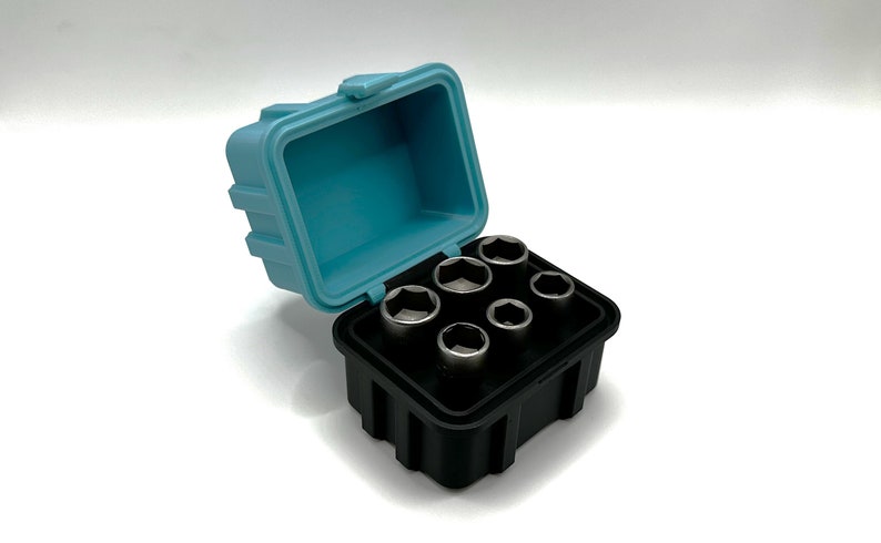 May include: A set of six silver socket wrenches in a black plastic case with a light blue lid. The case is open and the wrenches are visible.