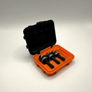 May include: A black plastic case with an orange interior holds three drill bits. The drill bits are labeled with sizes 1/8, 5/32, and 3/16.
