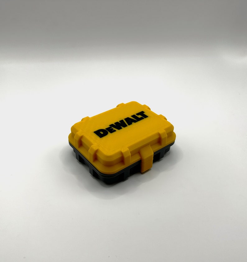 May include: A yellow plastic storage case with a black lid and the word "DEWALT" printed in black on the top.