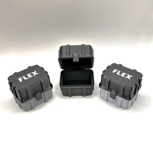 May include: Three small black and gray plastic storage cases with the word "FLEX" printed in white on the front.