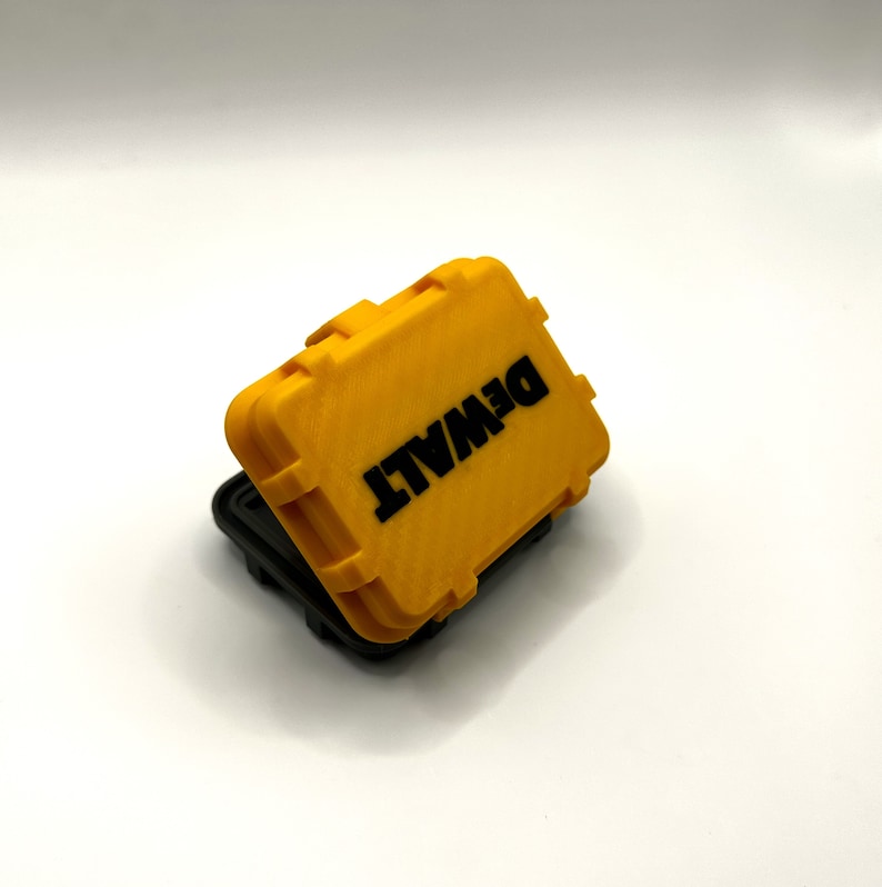May include: A yellow plastic storage case with the word "DEWALT" printed in black letters on the top.