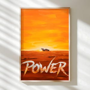 May include: An orange and yellow abstract art print in a wooden frame. The artwork depicts a futuristic car on a reddish-brown landscape under a bright orange sky. The word "POWER" is written in white and orange brushstrokes.