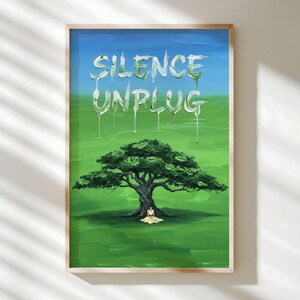 May include: A framed art print with a serene landscape. The artwork features a large green tree with a person sitting beneath it on a green field. The sky transitions from blue to green, with the words "SILENCE UNPLUG" in white.
