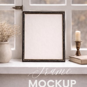 May include: A black framed square mockup frame with a white interior, sitting on a white windowsill. A vase with dried flowers, a candle, and a book are also on the windowsill. The text "Frame Mockup" is at the bottom.