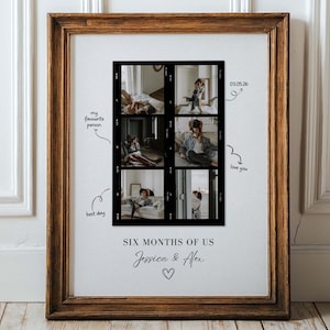 May include: A framed print with a brown wooden frame. The print features six black and white photos arranged in a grid. Text includes "SIX MONTHS OF US", names, and handwritten notes like "my favourite person" and "love you".