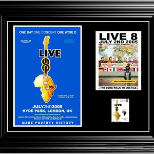 May include: A framed poster for the Live 8 concert, held on July 2nd, 2005, in Hyde Park, London. The poster features a guitar shaped like the continent of Africa, with the text "Live 8" and "Make Poverty History".