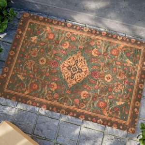 May include: A rectangular doormat featuring a dark green background with an intricate floral pattern in shades of orange, red, and brown. The design includes a central medallion and a decorative border, creating a detailed, multi-coloured surface.
