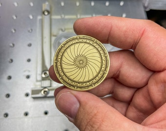 Brass coin for Stargate fans like me. Iris closed on one side and a surprise on the other side. MGM had my last two taken down…