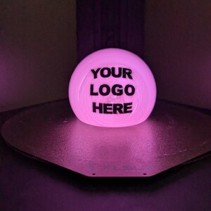 May include: A white sphere with the text "YOUR LOGO HERE" printed in black.