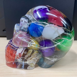 Skull large resin lighted Skull of skulls, clear and filled with small mixed color skulls.