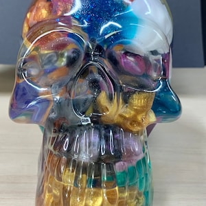 Large resin lighted Skull of skulls, clear and filled with small mixed color skulls.